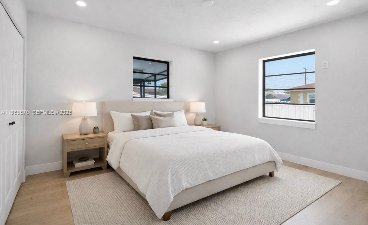 4485 East 8th Avenue Hialeah, FL 33013 - Photo 10 of 26 a bedroom with a bed and a window