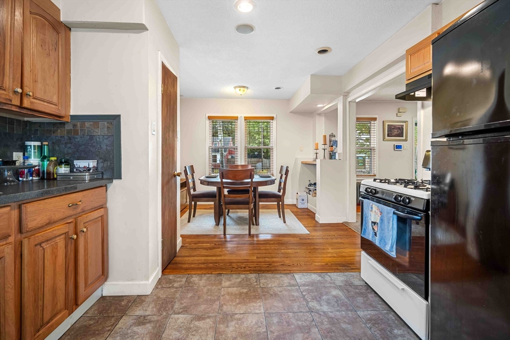 403 Allen Street Springfield, MA 01118 - Photo 8 of 24 a kitchen with stainless steel appliances granite countertop a refrigerator and a stove top oven