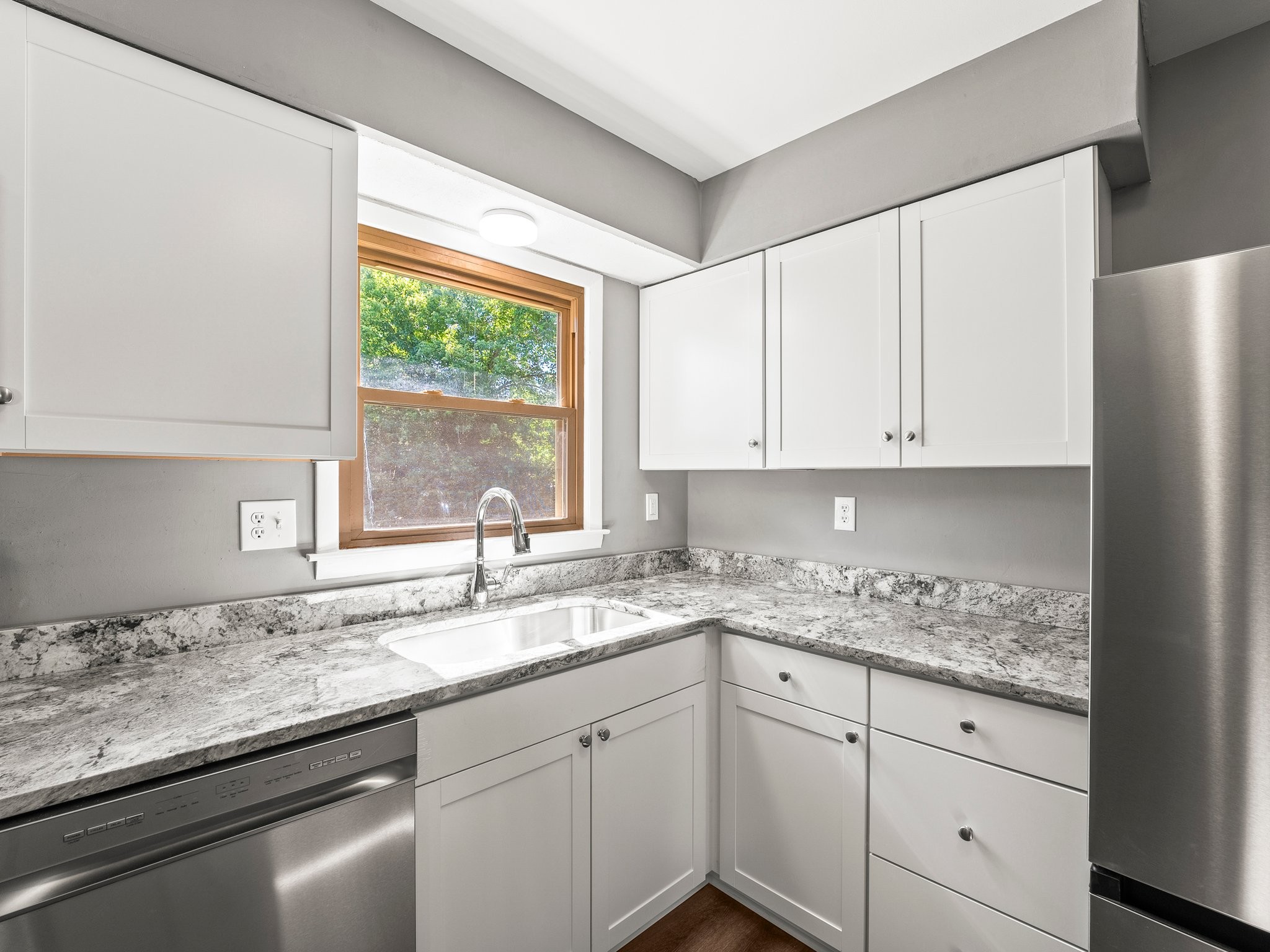 103 Cedar Street Huntland, TN 37345 - Photo 13 of 26 a kitchen with granite countertop white cabinets and a window
