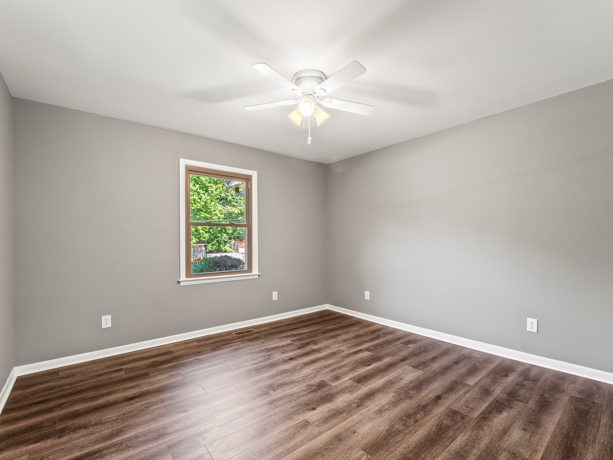 103 Cedar Street Huntland, TN 37345 - Photo 19 of 26 wooden floor in an empty room with a window