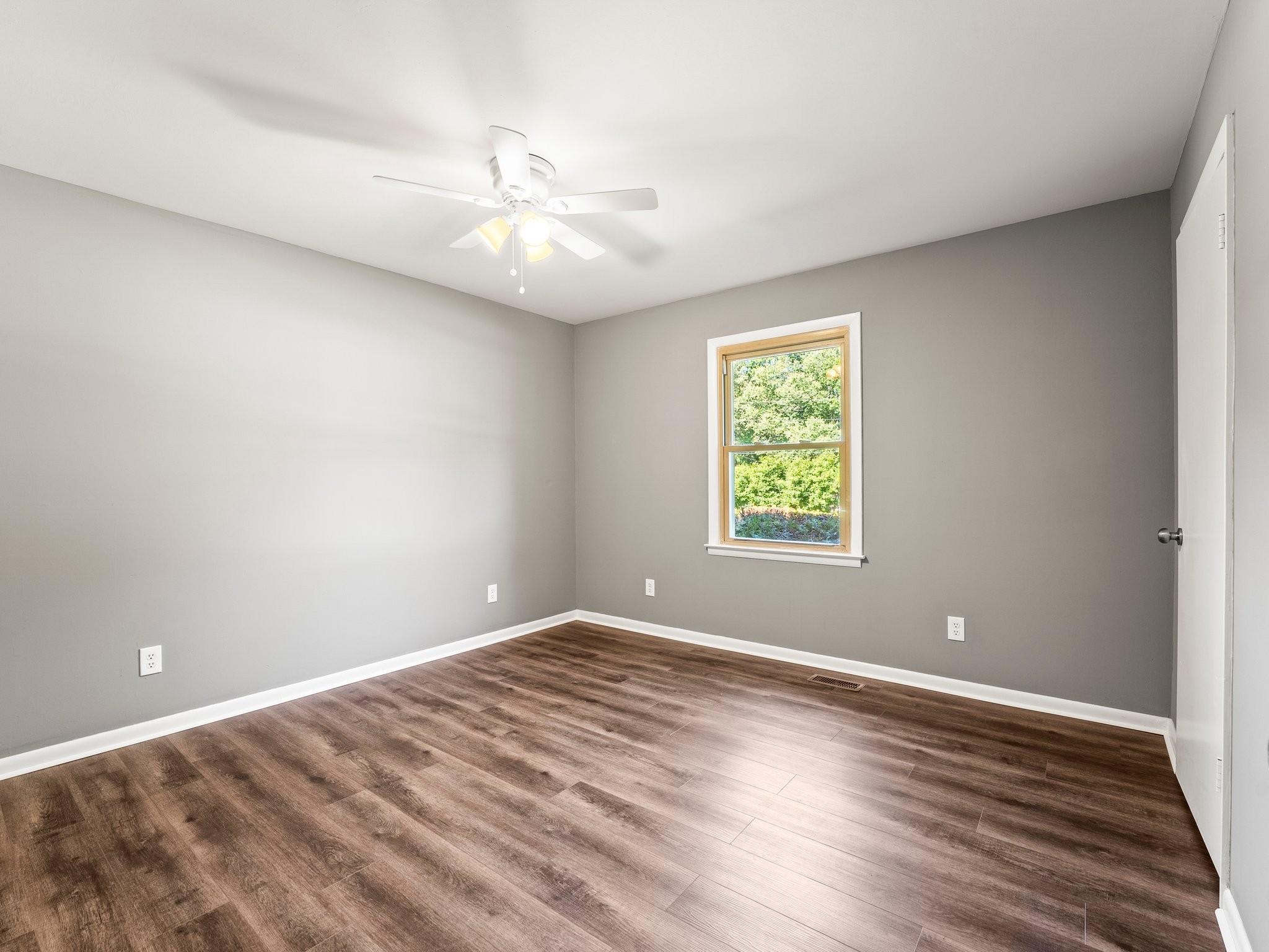 103 Cedar Street Huntland, TN 37345 - Photo 20 of 26 a view of an empty room with wooden floor and a window
