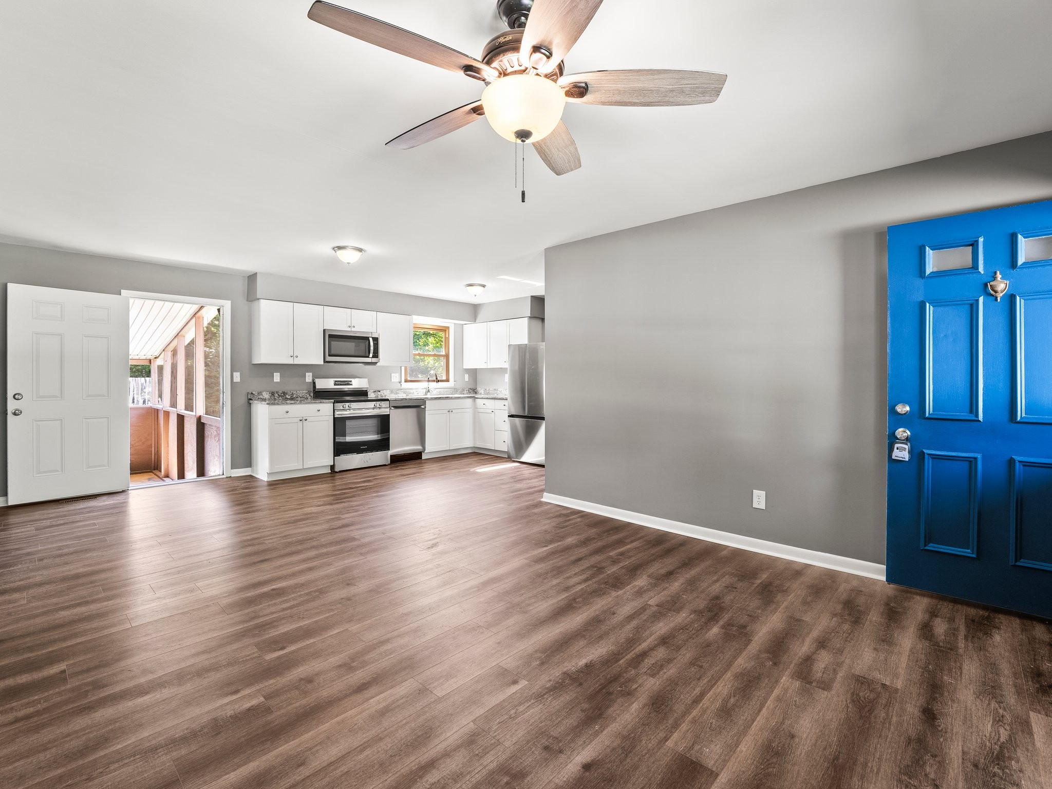 103 Cedar Street Huntland, TN 37345 - Photo 7 of 26 a view of a kitchen with a stove cabinets wooden floor and a ceiling fan
