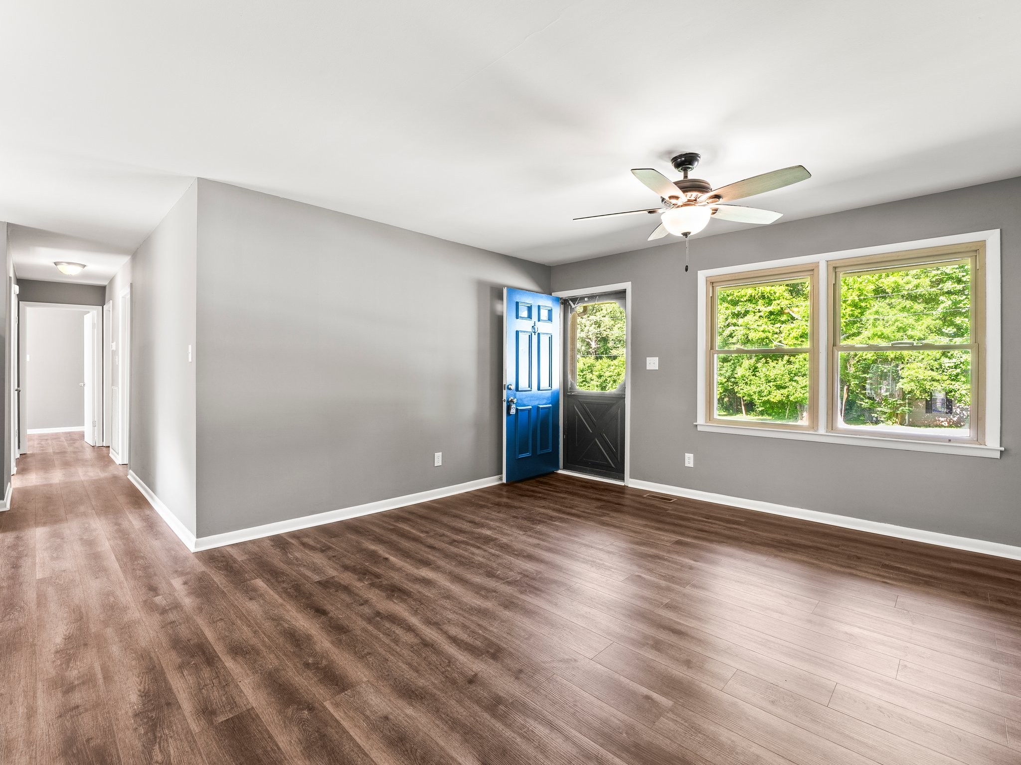 103 Cedar Street Huntland, TN 37345 - Photo 8 of 26 a view of an empty room with a window and wooden floor