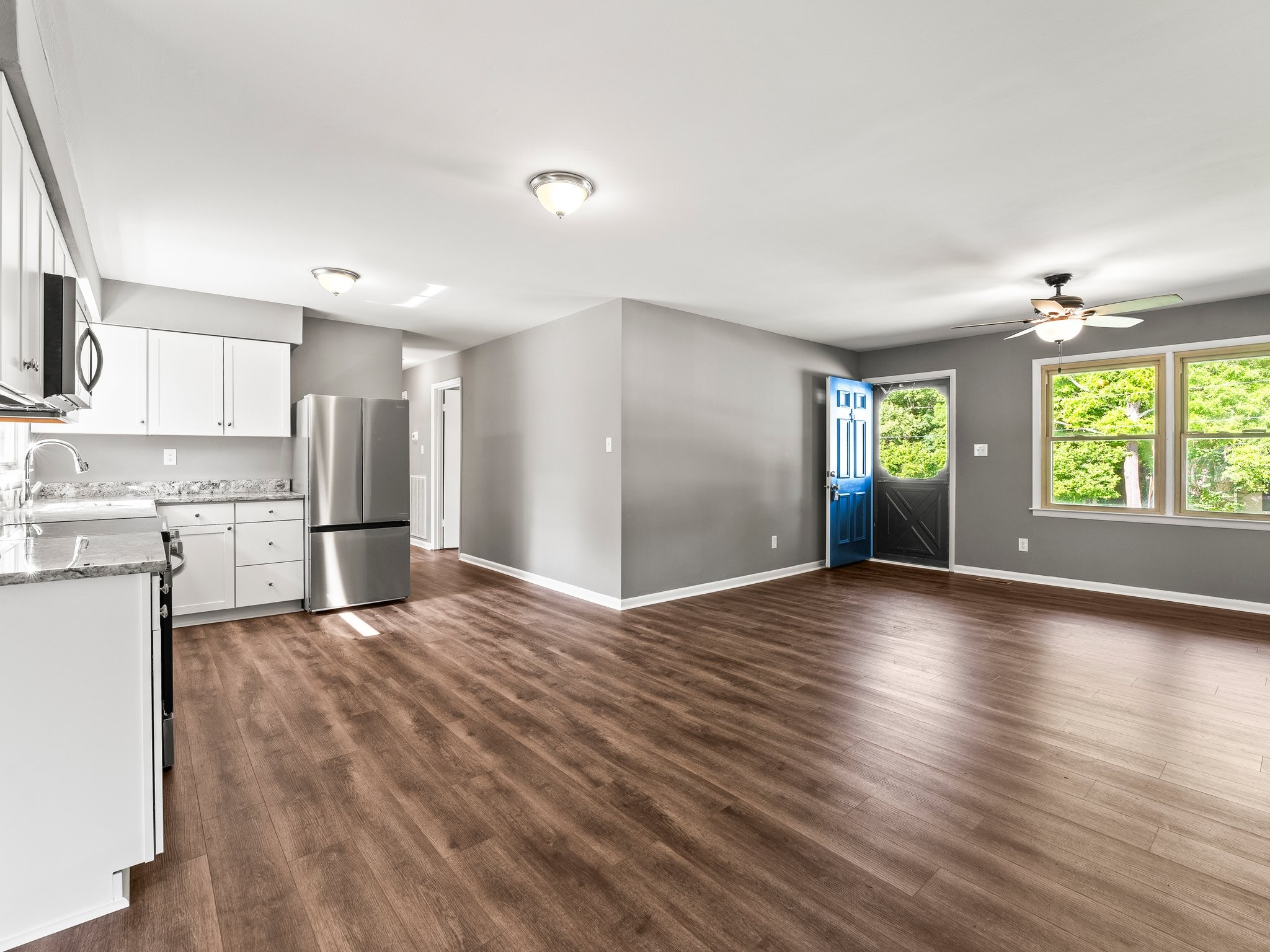 103 Cedar Street Huntland, TN 37345 - Photo 9 of 26 a view of an empty room with window and wooden floor