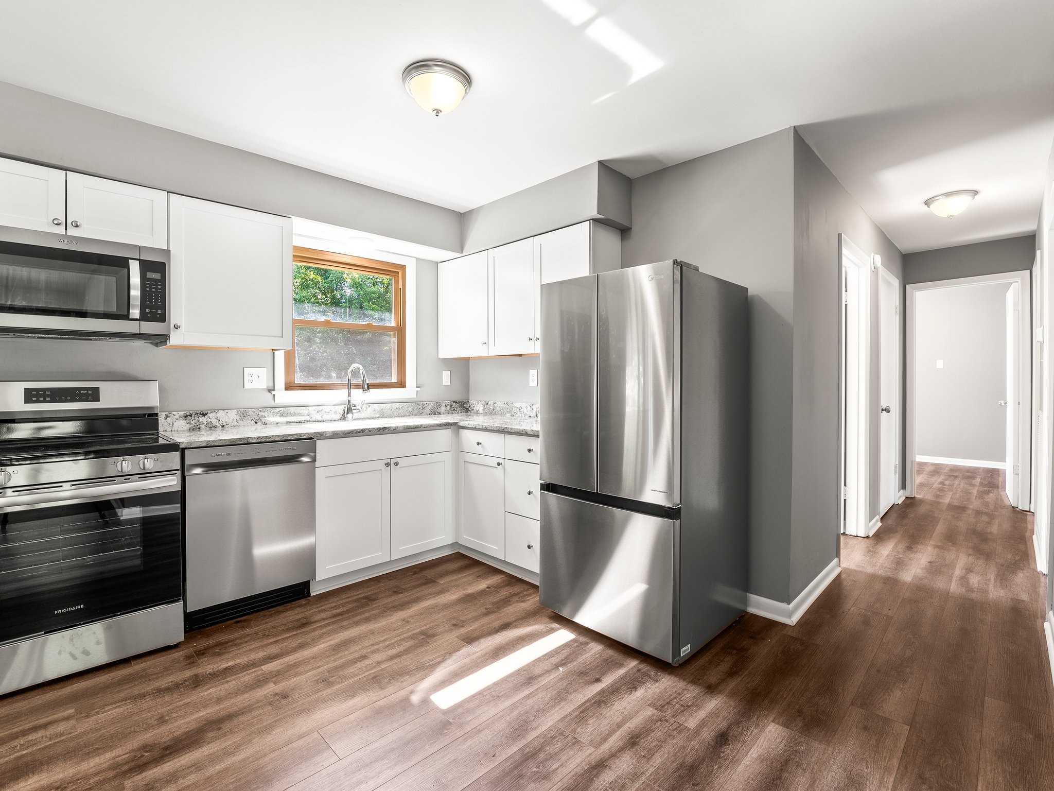 103 Cedar Street Huntland, TN 37345 - Photo 10 of 26 a kitchen with a refrigerator cabinets and wooden floor
