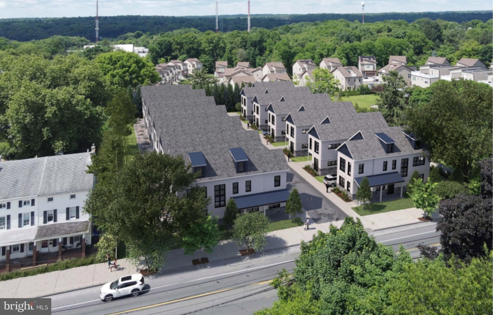 an aerial view of multiple houses with a yard