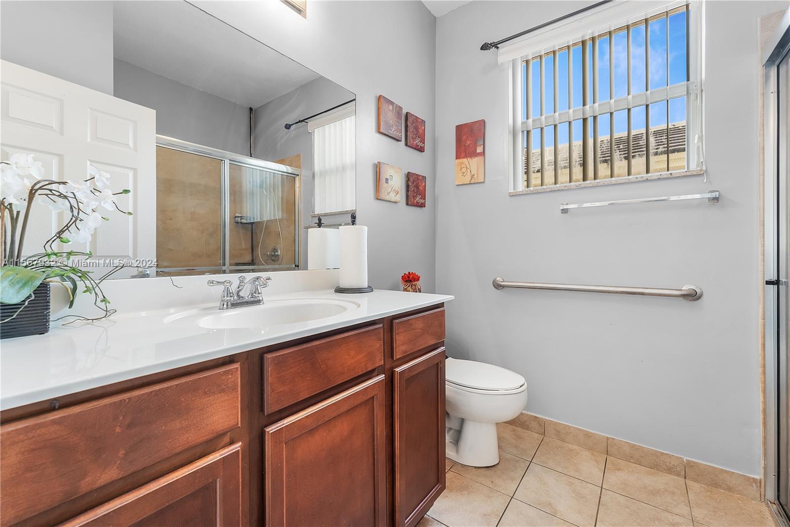 657 Southeast 30th Terrace Homestead, FL 33033 - Photo 14 of 53 a bathroom with a sink toilet and a mirror