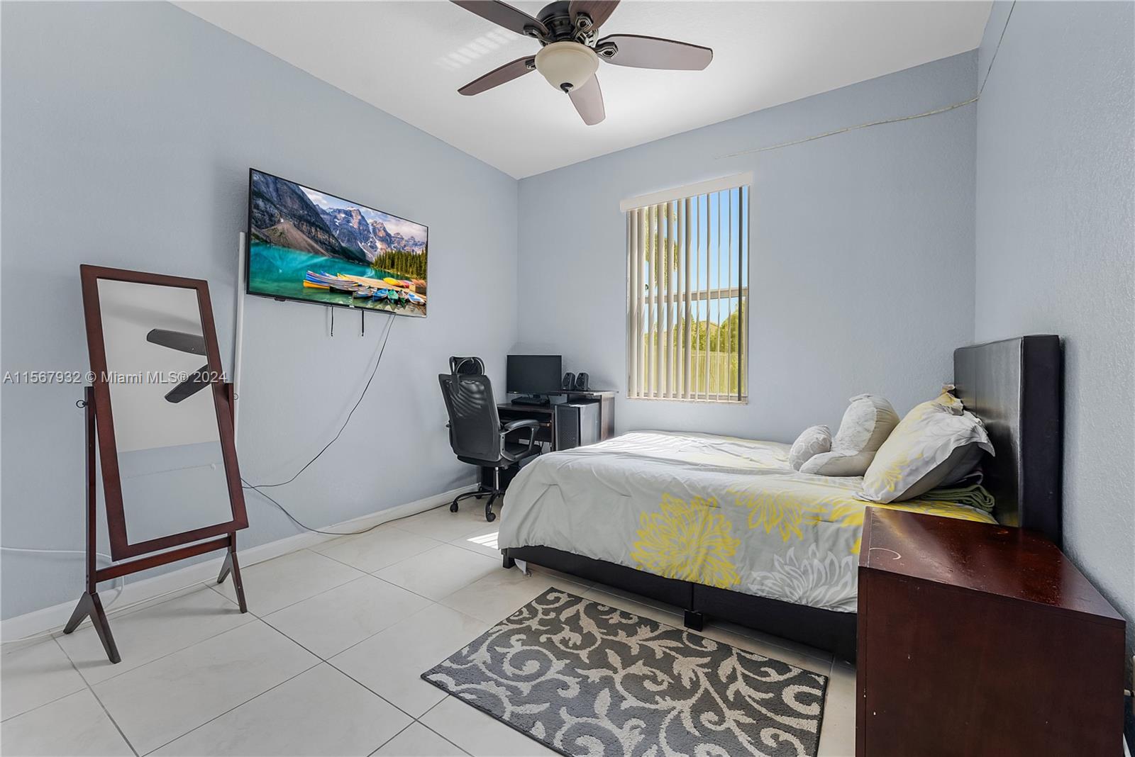 657 Southeast 30th Terrace Homestead, FL 33033 - Photo 15 of 53 a bedroom with a bed and a window