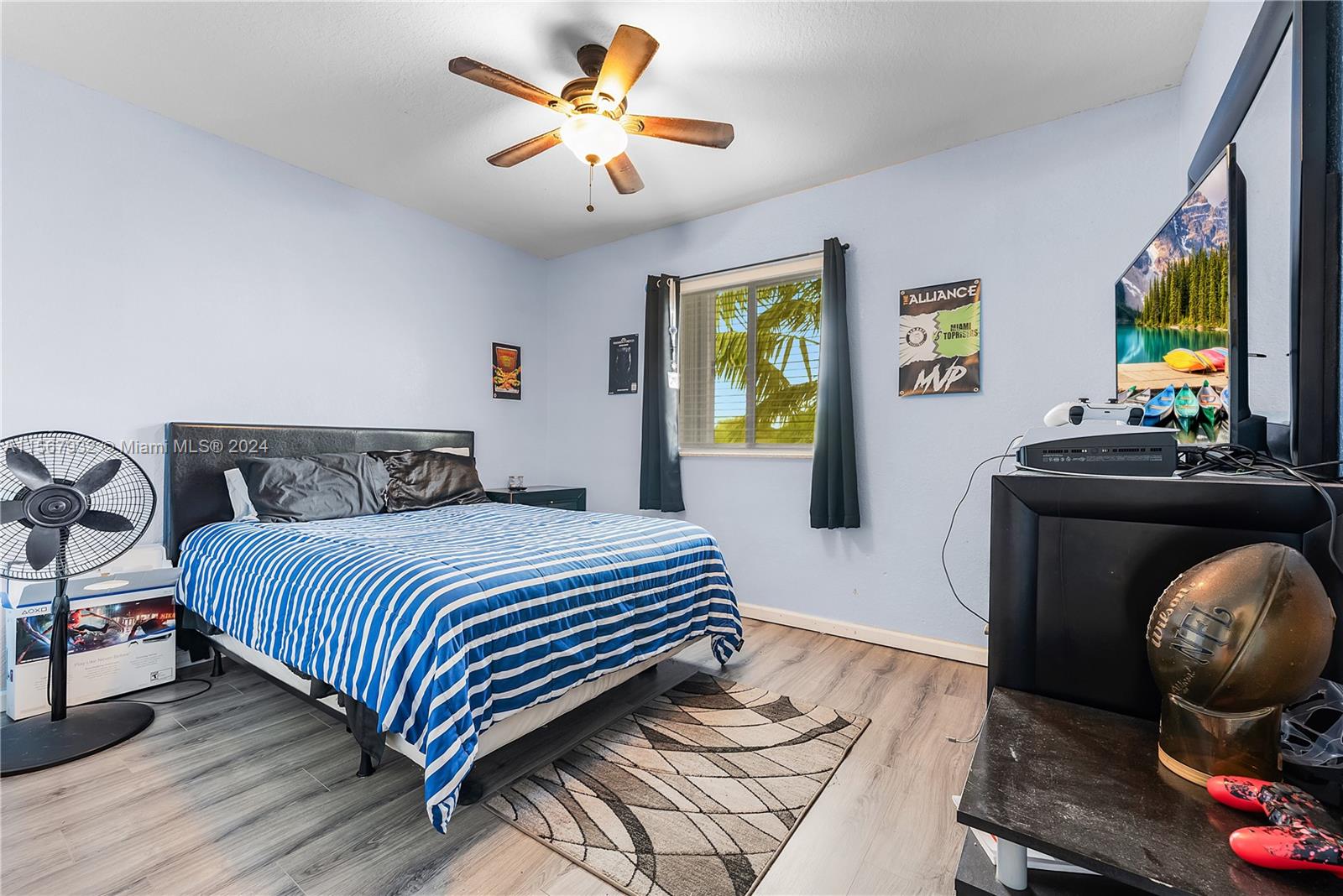 657 Southeast 30th Terrace Homestead, FL 33033 - Photo 16 of 53 a bedroom with a bed and a chandelier