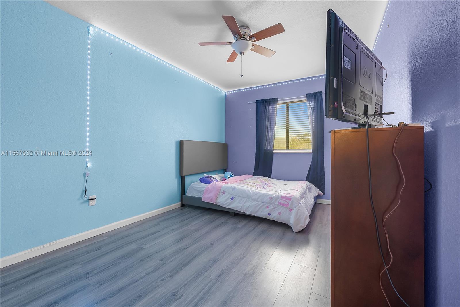 657 Southeast 30th Terrace Homestead, FL 33033 - Photo 17 of 53 a bedroom with a bed and wooden floor