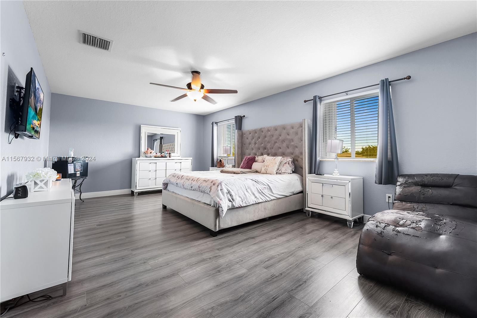 657 Southeast 30th Terrace Homestead, FL 33033 - Photo 21 of 53 a bedroom with a bed and a chandelier