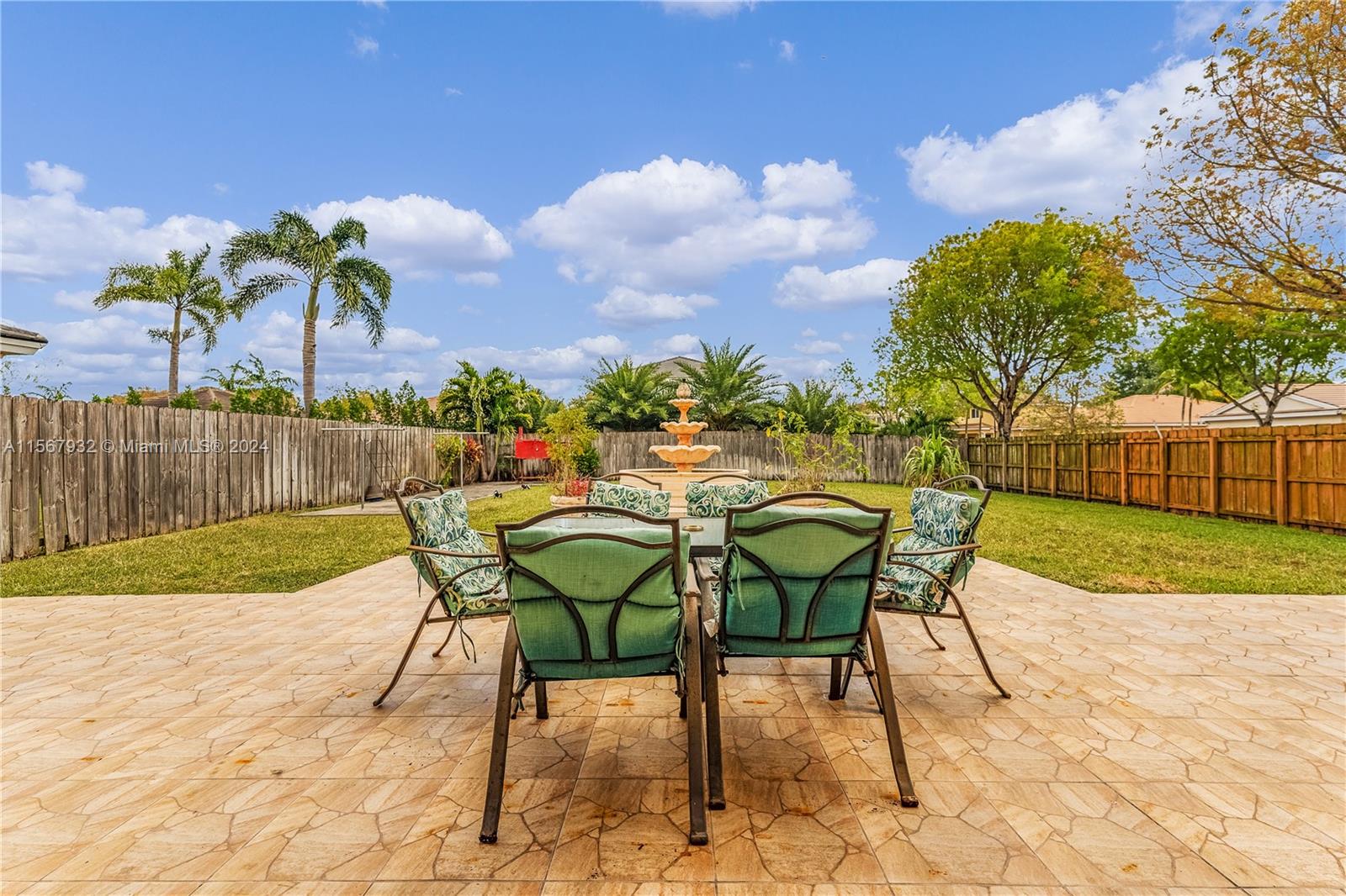 657 Southeast 30th Terrace Homestead, FL 33033 - Photo 30 of 53 a view of a chairs and table in the backyard
