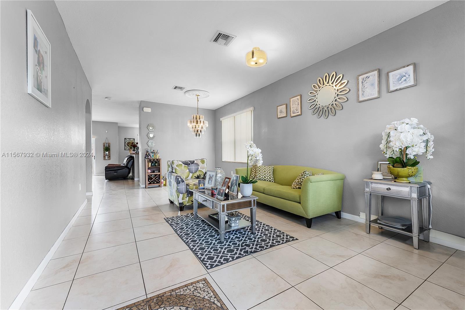 657 Southeast 30th Terrace Homestead, FL 33033 - Photo 3 of 53 a living room with furniture and a table