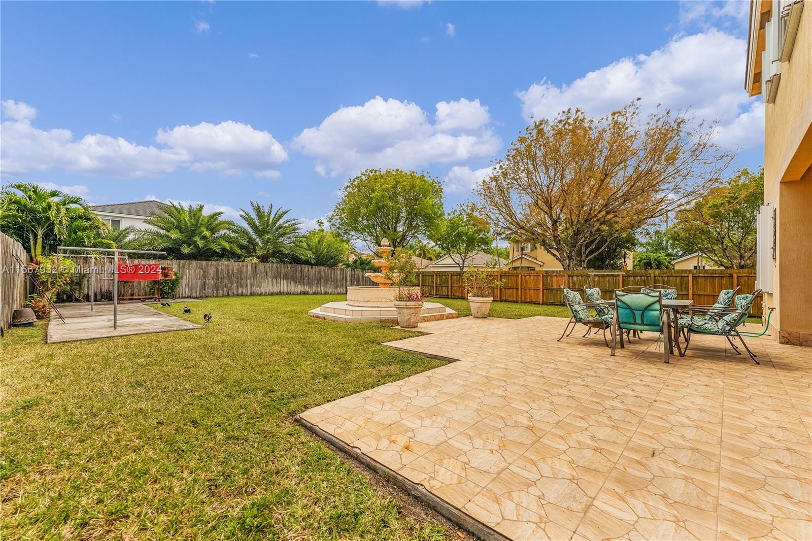 657 Southeast 30th Terrace Homestead, FL 33033 - Photo 31 of 53 a view of a swimming pool with a bench and lawn chairs