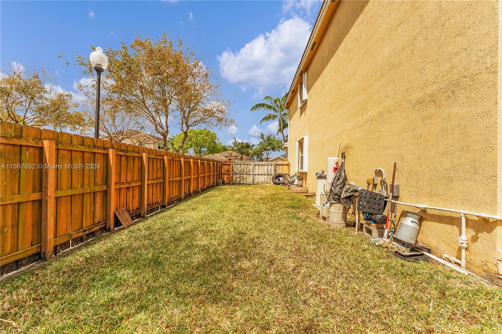 657 Southeast 30th Terrace Homestead, FL 33033 - Photo 33 of 53 a view of a yard with wooden fence
