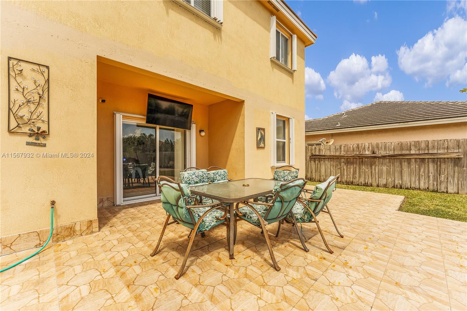 657 Southeast 30th Terrace Homestead, FL 33033 - Photo 37 of 53 a patio with a table and chairs