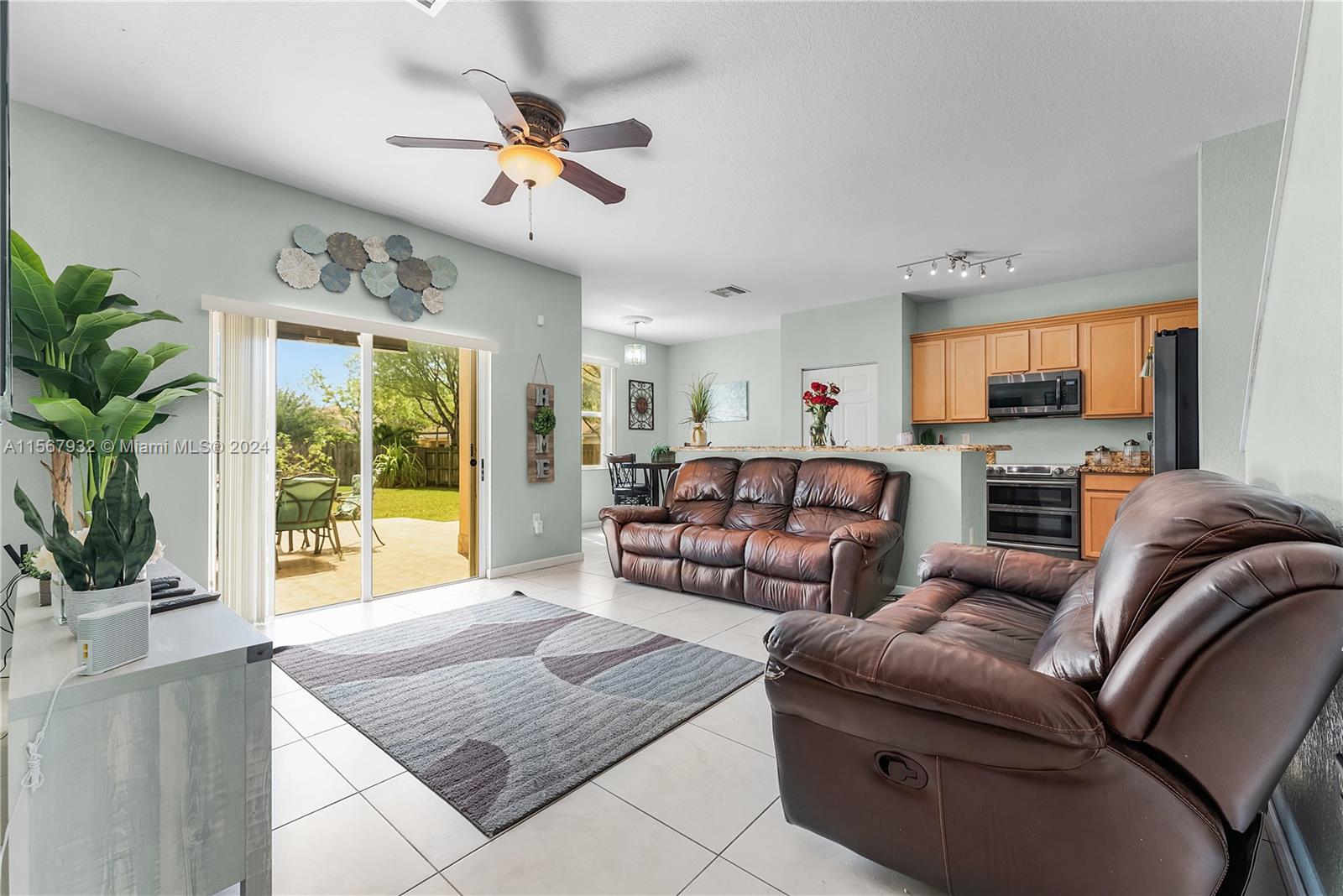 657 Southeast 30th Terrace Homestead, FL 33033 - Photo 6 of 53 a living room with furniture and a large window with garden view