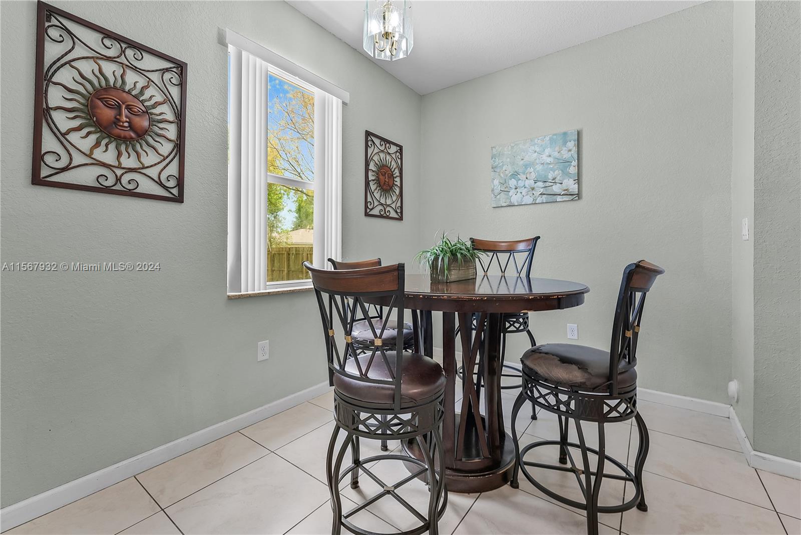 657 Southeast 30th Terrace Homestead, FL 33033 - Photo 10 of 53 a view of a dining room with furniture and a window