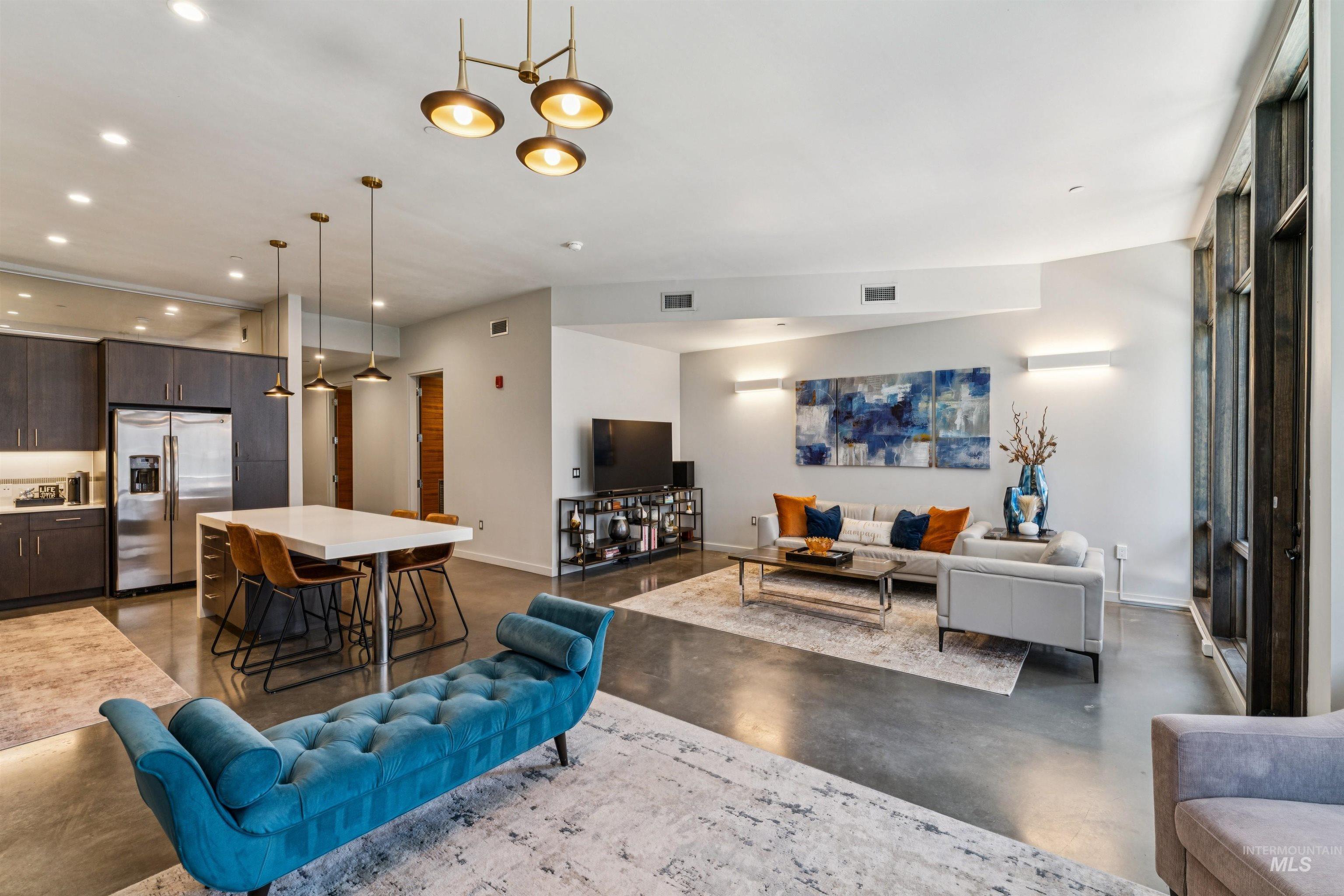 119 South 10th Street, Unit 307 Boise, ID 83702 - Photo 14 of 47 Open-concept living space featuring high ceilings and polished concrete flooring