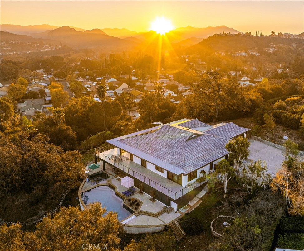 an aerial view of houses with a mountain