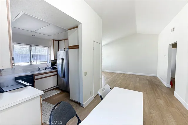 a kitchen with a refrigerator and a stove