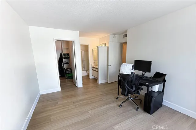 a view of a workspace with furniture and wooden floor
