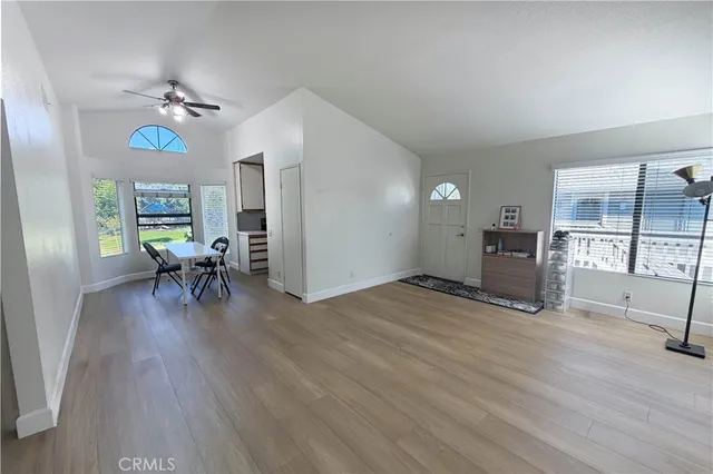 a view of a livingroom with furniture and a table wooden floor