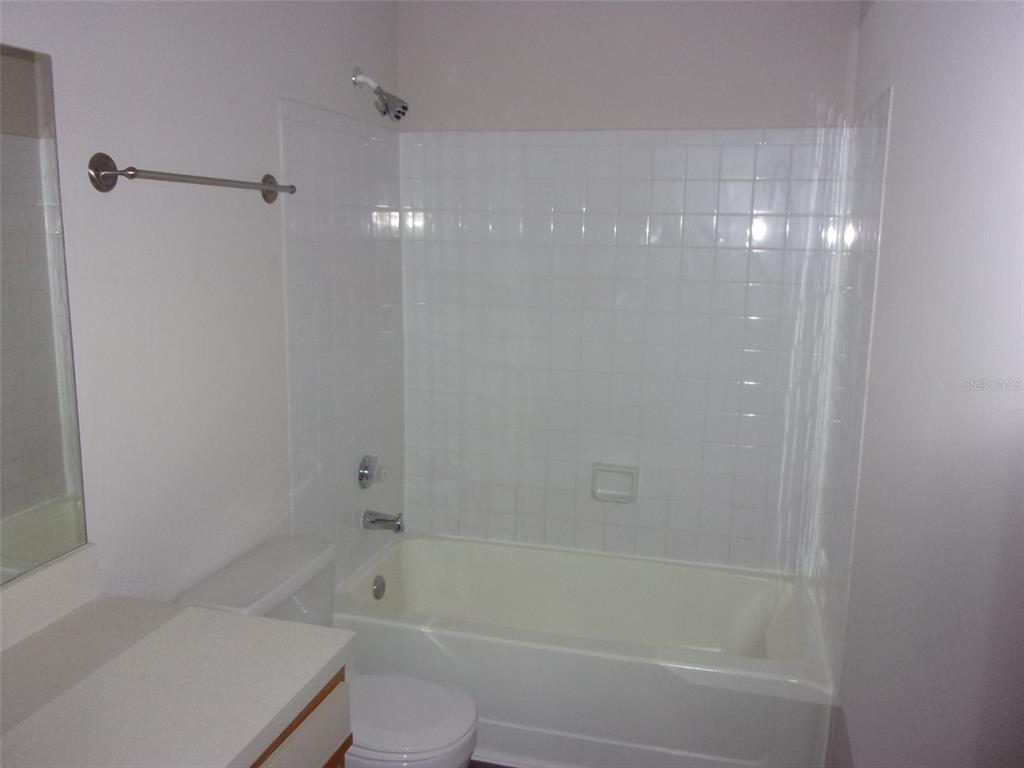 246 Afton Square, Unit 304 Altamonte Springs, FL 32714 - Photo 15 of 18 a bathroom with a bathtub shower and toilet