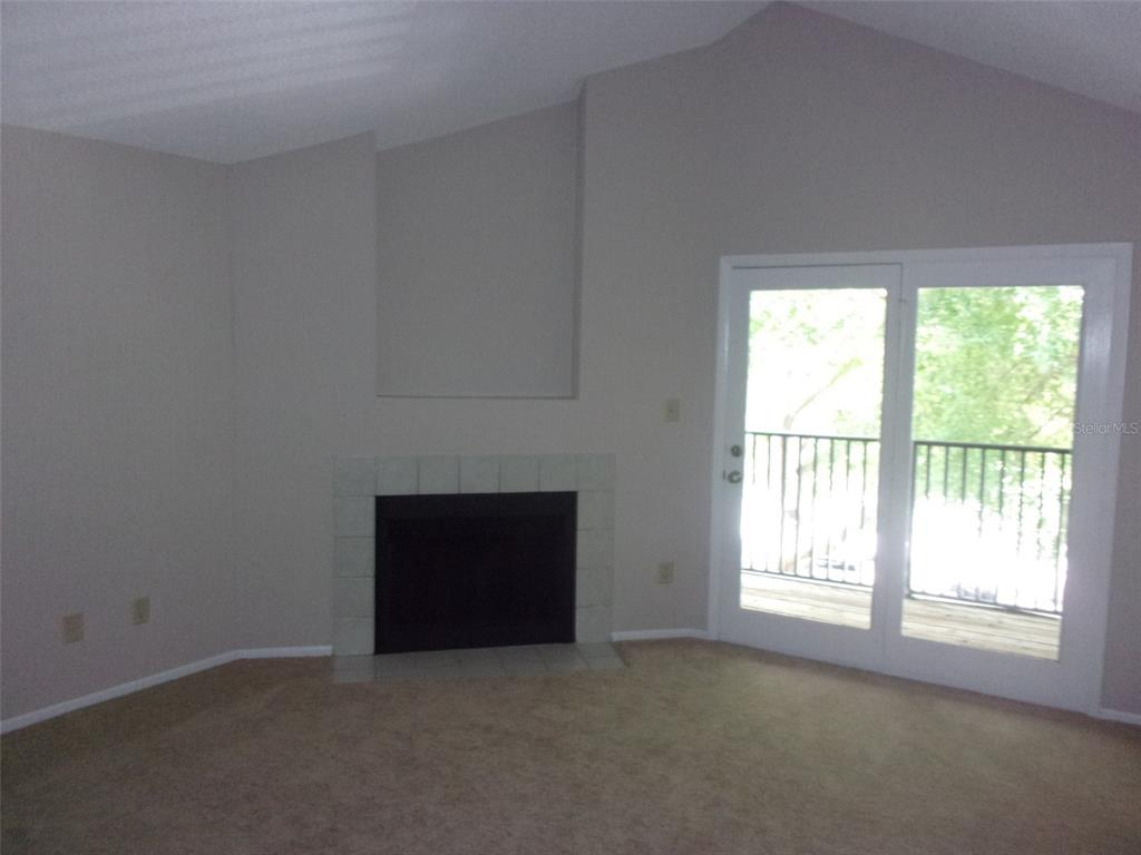246 Afton Square, Unit 304 Altamonte Springs, FL 32714 - Photo 4 of 18 an empty room with a fireplace