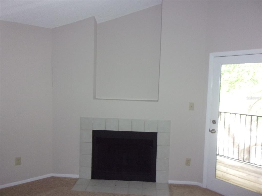 246 Afton Square, Unit 304 Altamonte Springs, FL 32714 - Photo 6 of 18 a room with a fireplace and a window