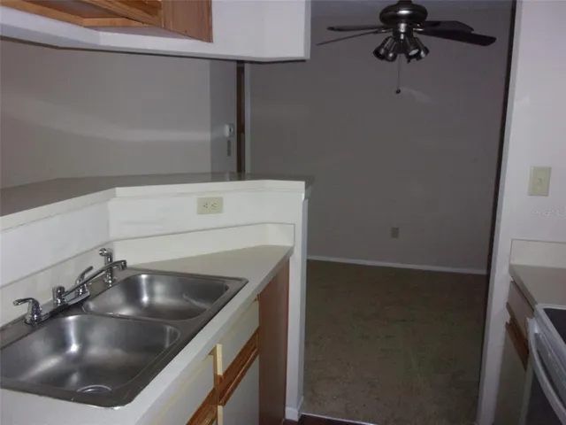 a kitchen with a sink and refrigerator
