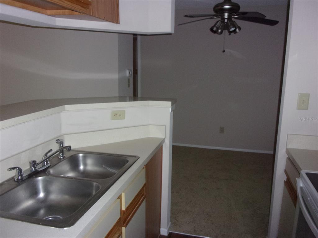 246 Afton Square, Unit 304 Altamonte Springs, FL 32714 - Photo 9 of 18 a kitchen with a sink and refrigerator