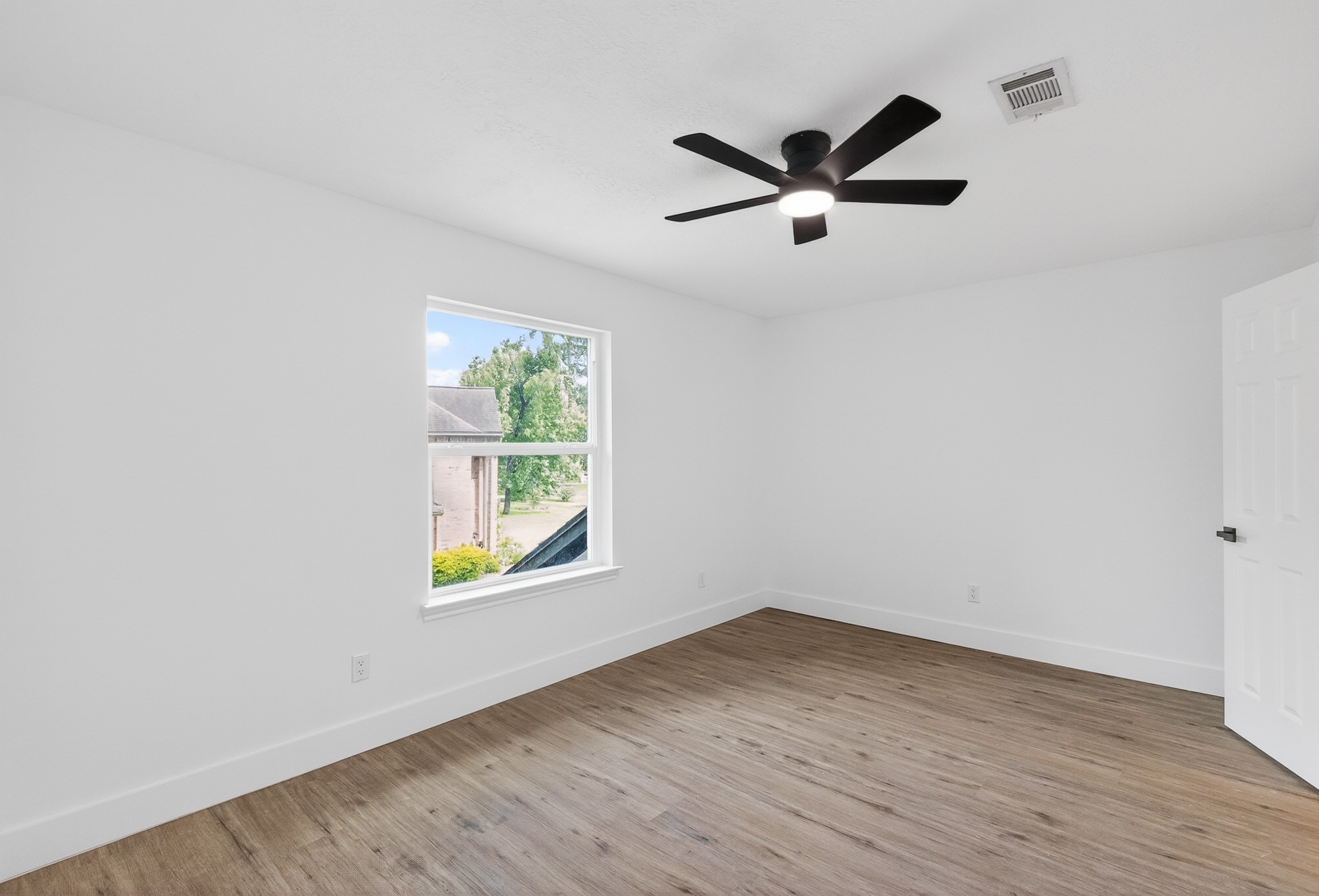 523 Rampart Lane Conroe, TX 77302 - Photo 32 of 41 Bright secondary bedroom with abundant natural light, modern finishes, and flexible space for guests, children, or a home office.
