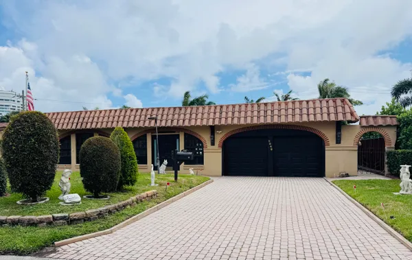 a front view of a house with a garden