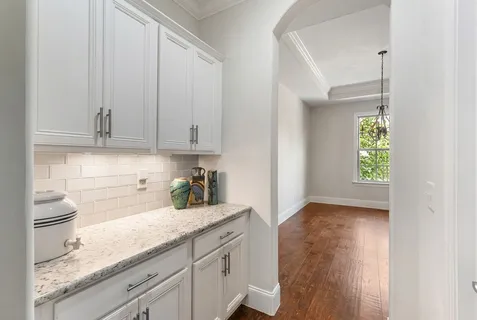 a kitchen with granite countertop a sink stove and refrigerator