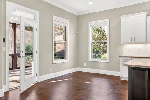 a view of a dining room with furniture and windows