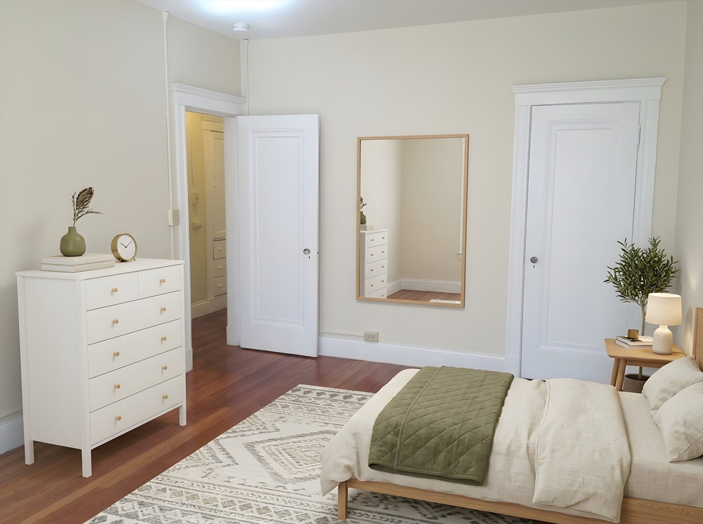 a bedroom with a bed and a dresser