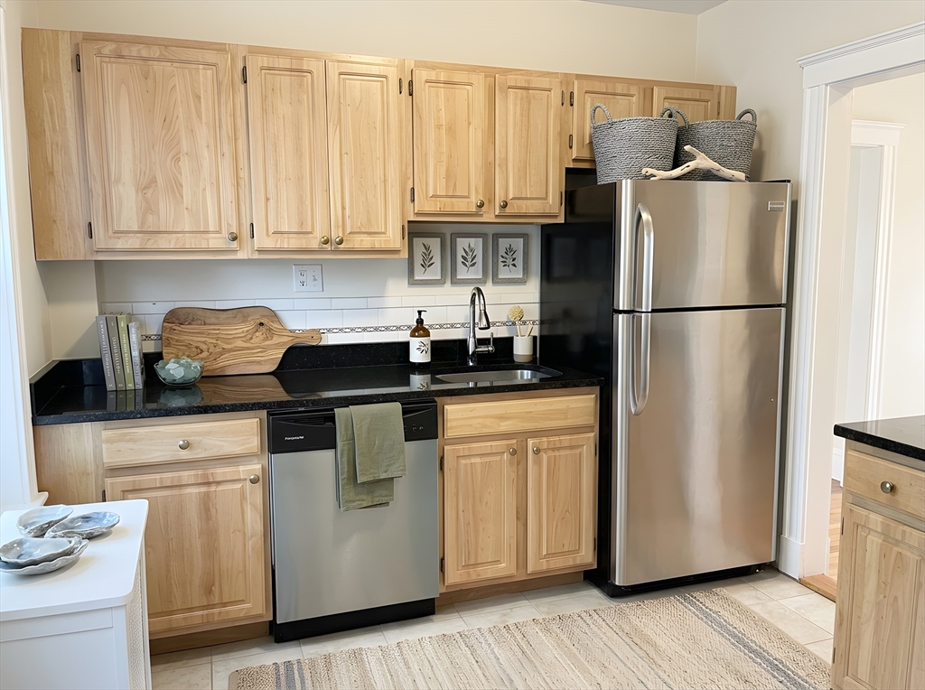 203-205 Winthrop Road, Unit 3 Brookline, MA 02445 - Photo 4 of 9 a kitchen with appliances a refrigerator and cabinets