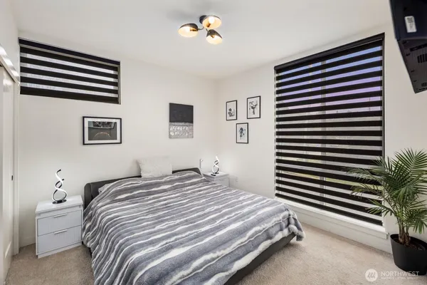 a bedroom with a bed and a painting on the wall
