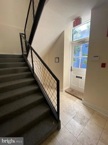 a view of entryway and hall with wooden floor