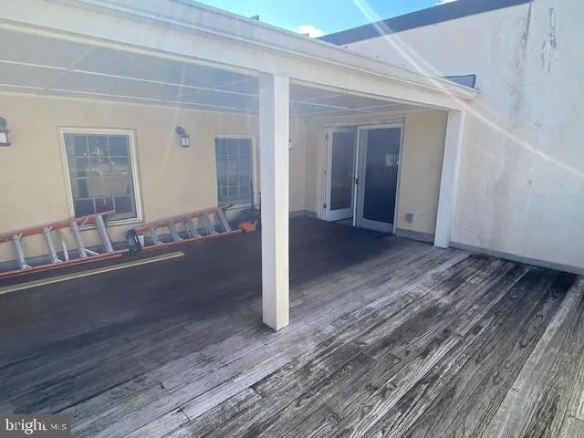a view of a hallway view with wooden floor and staircase