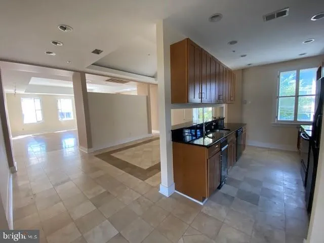 a kitchen with stainless steel appliances granite countertop a stove and a sink