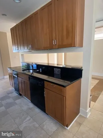 a kitchen with stainless steel appliances granite countertop a stove a sink a refrigerator and dishwasher