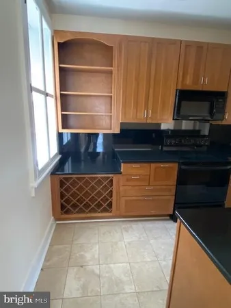 a kitchen with granite countertop a stove and a cabinet
