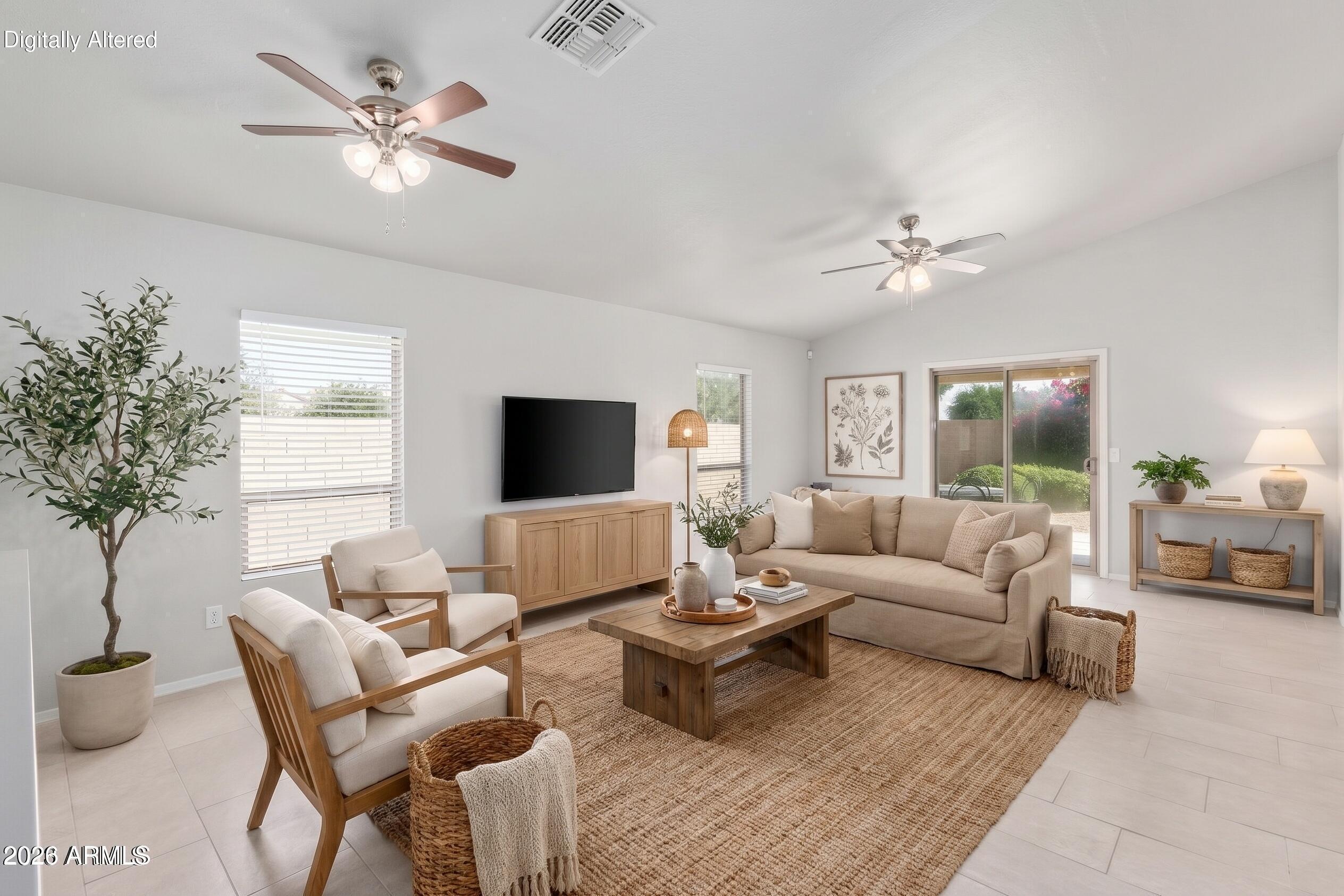 17715 West Redfield Road Surprise, AZ 85388 - Photo 2 of 36 a living room with furniture a chandelier and a window
