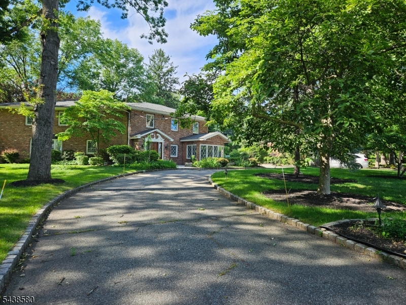 218 Devon Road Essex Fells, NJ 07021 - Photo 2 of 24 a front view of a house with yard and green space