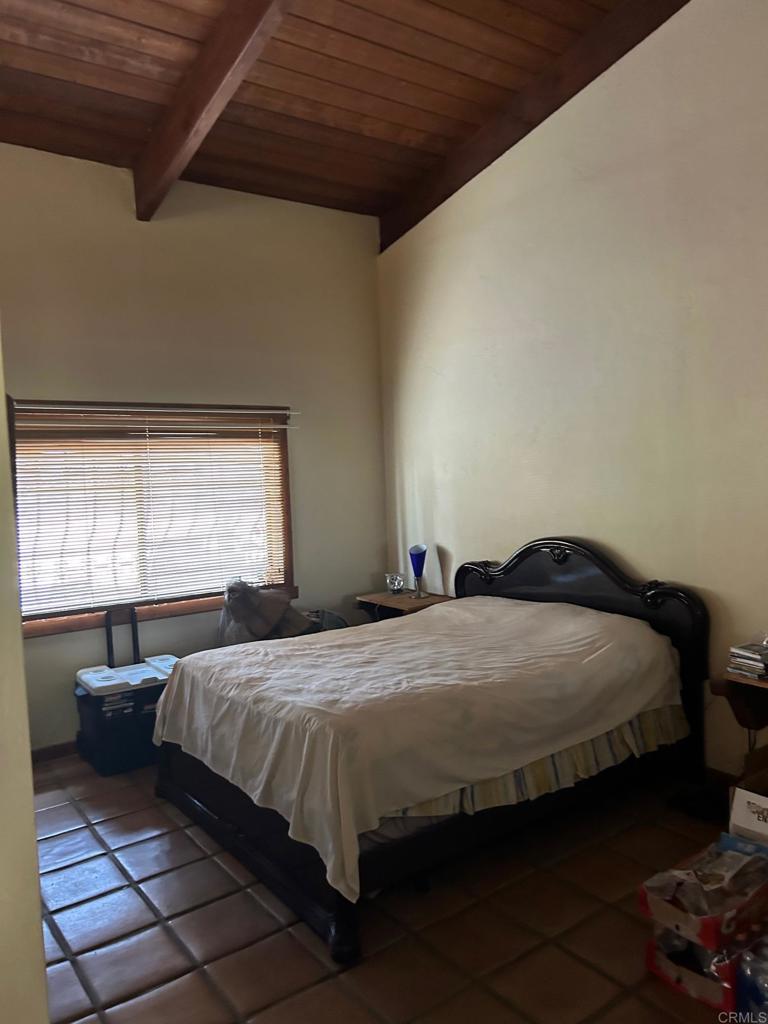 33444 Couser Canyon Road Valley Center, CA 92082 - Photo 9 of 11 a bedroom with a bed and window