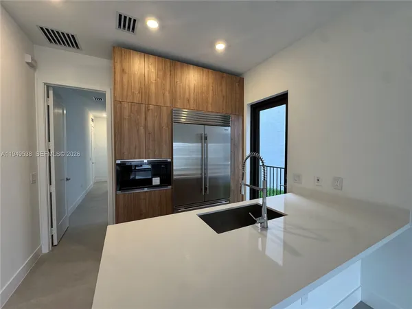 a kitchen with a refrigerator and a sink