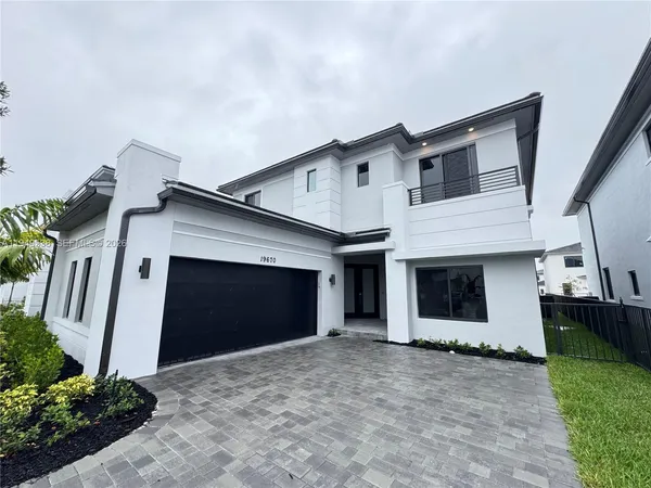 a front view of a house with a yard and garage