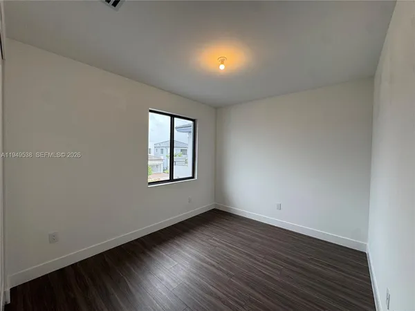 a view of a hallway with a wooden floor